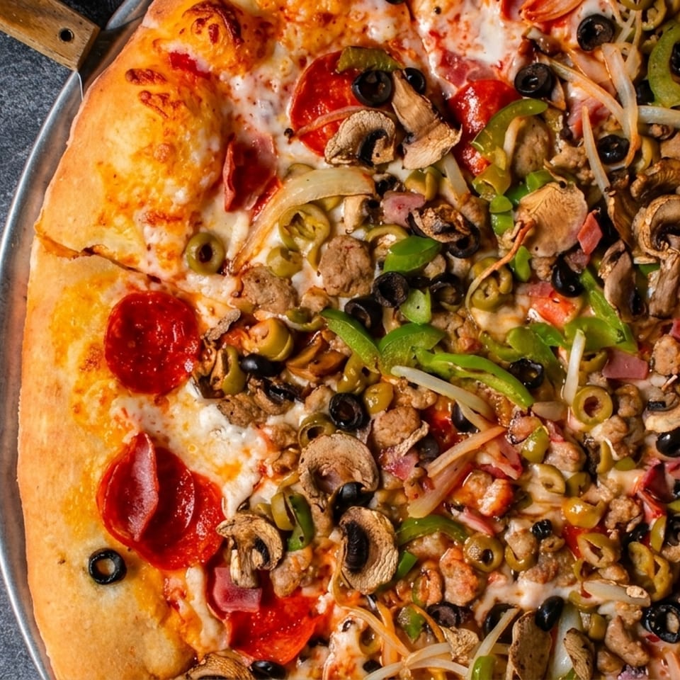 Half pepperoni, half supreme pizza with mushrooms, olives, onions, and peppers.